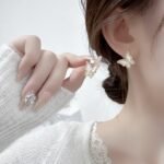 Mother of Pearl Butterfly Lariat Necklace Set shown in both gold and silver finishes. The set includes a Y-necklace with an MOP butterfly and pearl drop, and matching MOP butterfly stud earrings.