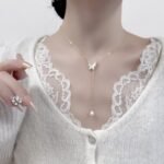 Mother of Pearl Butterfly Lariat Necklace Set shown in both gold and silver finishes. The set includes a Y-necklace with an MOP butterfly and pearl drop, and matching MOP butterfly stud earrings.