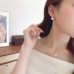 Wholesale Fan Shape Shell Set with natural Mother of Pearl fan motif and delicate CZ connector stones. The set includes a matching necklace and stud earrings, shown in both gold and platinum finishes on a black display.