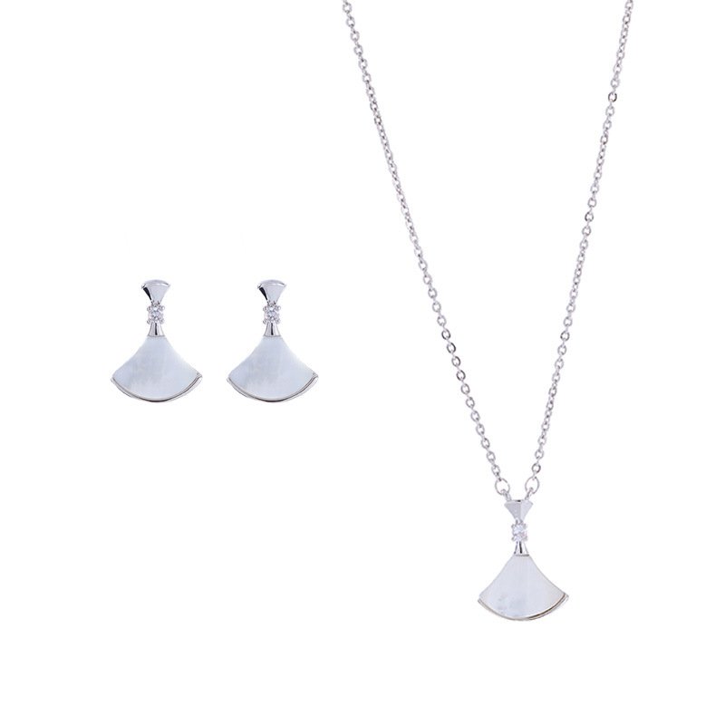 Wholesale Fan Shape Shell Set with natural Mother of Pearl fan motif and delicate CZ connector stones. The set includes a matching necklace and stud earrings, shown in both gold and platinum finishes on a black display.