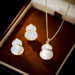 Mother of Pearl Gourd Necklace and Earrings Set in gold plating. The jewelry features a lucky gourd shape made of MOP shell with a CZ accent line across the center.
