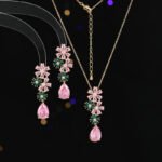 Wholesale Pink Green Floral Jewelry Set featuring pink and green micro-inlaid zircon flower clusters and elegant pink teardrop dangle. 18K gold plated copper accessories from JuneJewelry.com.