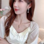 Wholesale Pink Green Floral Jewelry Set featuring pink and green micro-inlaid zircon flower clusters and elegant pink teardrop dangle. 18K gold plated copper accessories from JuneJewelry.com.