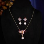 Wholesale Pink Cherry Blossom Jewelry Set on JuneJewelry.com: 18K gold plated copper necklace and earrings with micro-inlaid pink zircon stones, romantic and highly versatile design.