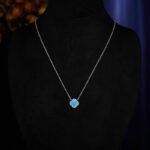 Wholesale Light Luxury Lucky Clover Turquoise Blue Set, featuring the four-leaf clover motif inlaid with vibrant turquoise blue stones, includes matching niche design earrings and a high-end sense necklace, from junejewelry.com.