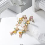 Wholesale Colorful Zircon Flower Tassel Jewelry Set in Dopamine style, featuring multi-colored inlaid zircon gemstones, a flower tassel necklace (choker/collar chain), and matching earrings, available in 18K Gold Plated or White Gold Plated copper from junejewelry.com.