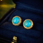 Wholesale Turquoise Pearl Beaded Set on a white background. Includes a long necklace with a round turquoise-colored pendant, matching gold-textured stud earrings, and an adjustable pearl slider bracelet.