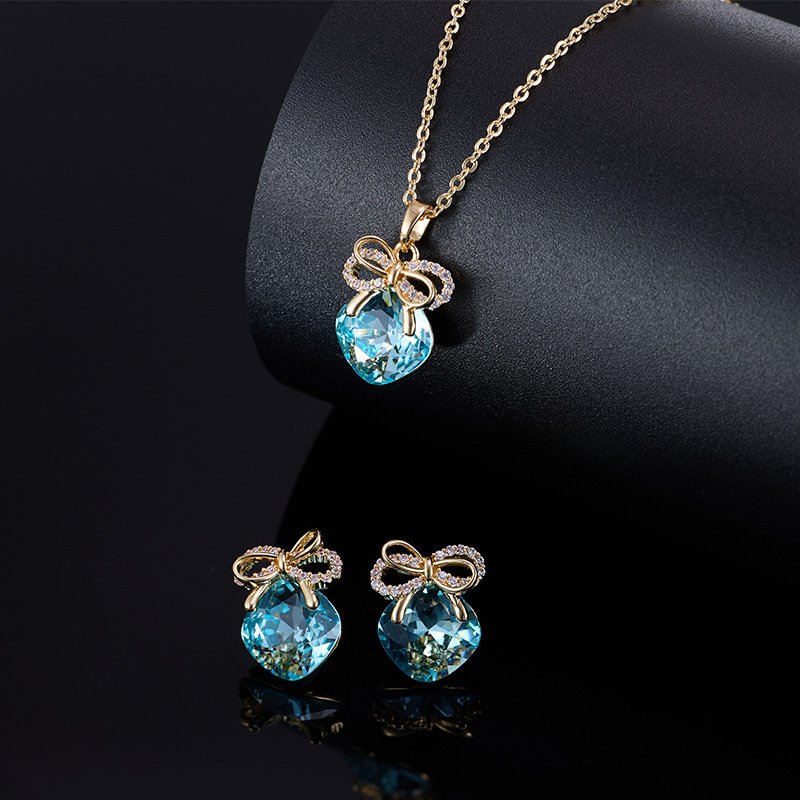 T-064 (1) Blue crystal bow jewelry set wholesale – light-blue crystal necklace and matching bowknot earrings, luxury and elegant design.