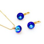 Shop wholesale blue crystal gold plated set featuring simple round Swarovski element. High quality 18K plated brass at factory prices from JuneJewelry.com.