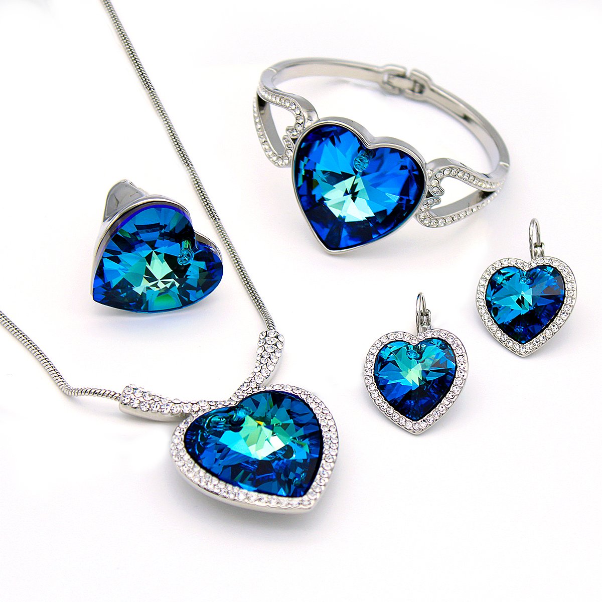 A500006S-001.842.A Wholesale 4-Piece Swarovski Element Heart Jewelry Set in silver plating, showing necklace, bangle, ring, and earrings with blue crystals.