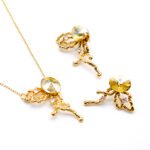 Wholesale abstract butterfly jewelry set with light blue Swarovski Elements crystal and 18K gold plated fluid-design necklace and stud earrings from JuneJewelry.com.