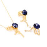 Wholesale abstract butterfly jewelry set with light blue Swarovski Elements crystal and 18K gold plated fluid-design necklace and stud earrings from JuneJewelry.com.