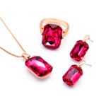 Wholesale pink crystal rectangular jewelry set in rose gold plating with a large faceted pink crystal ring, pendant, and matching drop earrings from JuneJewelry.com – unique and high-quality.