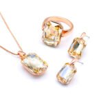 Wholesale pink crystal rectangular jewelry set in rose gold plating with a large faceted pink crystal ring, pendant, and matching drop earrings from JuneJewelry.com – unique and high-quality.