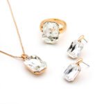 Wholesale pink crystal rectangular jewelry set in rose gold plating with a large faceted pink crystal ring, pendant, and matching drop earrings from JuneJewelry.com – unique and high-quality.