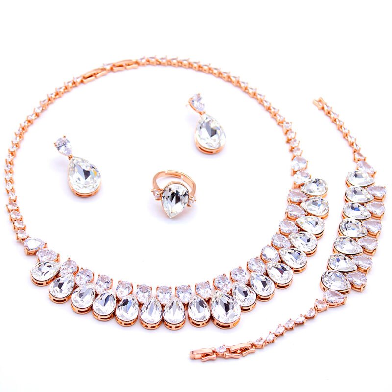 Wholesale Pear Crystal Drop Jewelry Set with rose gold plating, clear pear-shaped crystals – necklace, bracelet, earrings, and ring from JuneJewelry.com factory price.