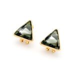 A pair of Swarovski Element stud earrings, showing a close-up of the single, glittering triangle-cut crystal set in a simple three or four-prong stud mounting.