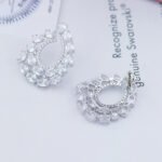 Wholesale open teardrop earrings with oval cubic zirconia on real gold plated brass and 925 silver pins from JuneJewelry.com.