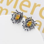 Wholesale turquoise burst earrings with emerald green zircon accents and 925 silver pins from JuneJewelry.com – celestial sunburst jewelry for bulk orders.