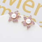 Wholesale pearl flower earrings with micro-pavé zircons and 925 silver needles on 14K gold plated brass from JuneJewelry.com – luxury floral jewelry for bulk orders.