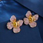 Wholesale flower zircon earrings with pink and yellow crystals on 18K gold plated brass from JuneJewelry.com – luxury floral jewelry for bulk purchase.