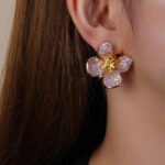 Wholesale flower zircon earrings with pink and yellow crystals on 18K gold plated brass from JuneJewelry.com – luxury floral jewelry for bulk purchase.