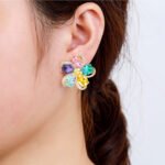 Wholesale colorful flower earrings with multi-colored zircons and 925 silver needles from JuneJewelry.com – unique floral fashion jewelry for bulk buyers.