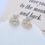 Wholesale flower zircon earrings with white pavé crystals on real gold plated copper from JuneJewelry.com – luxury floral studs for bulk orders.