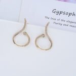 Wholesale serpent hoop earrings with white zircon pavé and green eyes on silver plated copper from JuneJewelry.com – trendy jewelry for bulk orders.