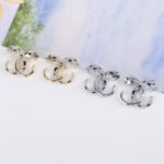 Wholesale leopard stud earrings with white zircon pave and green eyes on silver plated copper from JuneJewelry.com – unique animal jewelry.