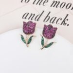 Wholesale tulip zircon earrings with white pave crystals on real gold plated copper from JuneJewelry.com – luxury floral studs.