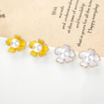 Wholesale pearl flower earrings with lavender enamel petals and zircons on 14K gold plated brass from JuneJewelry.com – unique floral jewelry for bulk purchase.