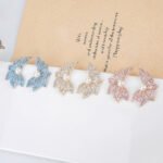 Wholesale butterfly pearl earrings with zircon pave and gold plated copper from JuneJewelry.com – luxury 925 silver needle fashion jewelry for bulk orders.