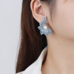 Wholesale butterfly pearl earrings with zircon pave and gold plated copper from JuneJewelry.com – luxury 925 silver needle fashion jewelry for bulk orders.