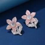 Wholesale panther head earrings with white zircon pavé and green eyes on silver plated copper from JuneJewelry.com – luxury animal jewelry.