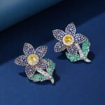 Wholesale panther head earrings with white zircon pavé and green eyes on silver plated copper from JuneJewelry.com – luxury animal jewelry.