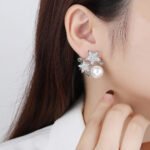 Wholesale flower pearl earrings with shimmering cubic zirconia petals and 925 silver needles from JuneJewelry.com – elegant floral jewelry for bulk purchase.
