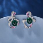 Wholesale red ribbon earrings with green zircons and 925 silver needles from JuneJewelry.com – unique bow-knot fashion jewelry for bulk buyers.