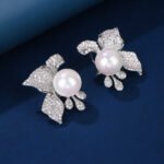 Wholesale floral pearl earrings with cubic zirconia petals and 925 silver needles from JuneJewelry.com – elegant flower jewelry for bulk orders.