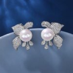Wholesale floral pearl earrings with cubic zirconia petals and 925 silver needles from JuneJewelry.com – elegant flower jewelry for bulk orders.
