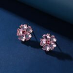 Wholesale pink flower earrings with heart-shaped zircon and 925 silver pins from JuneJewelry.com – cherry blossom fashion jewelry for bulk orders.
