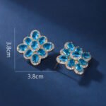 Wholesale multicolor flower earrings with red, blue, and yellow zircons on 14K gold plated brass from JuneJewelry.com – luxury floral jewelry for bulk orders.