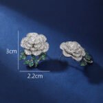 Wholesale flower zircon earrings with white pave petals on real gold plated copper from JuneJewelry.com – luxury floral jewelry for bulk orders.