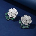 Wholesale flower zircon earrings with white pave petals on real gold plated copper from JuneJewelry.com – luxury floral jewelry for bulk orders.