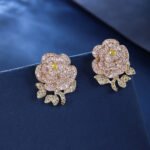 Wholesale flower zircon earrings with white pave petals on real gold plated copper from JuneJewelry.com – luxury floral jewelry for bulk orders.