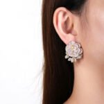 Wholesale flower zircon earrings with white pave petals on real gold plated copper from JuneJewelry.com – luxury floral jewelry for bulk orders.