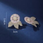Wholesale zircon flower earrings with white pavé petals on real gold plated copper from JuneJewelry.com – luxury floral studs for bulk orders.