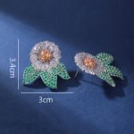 Wholesale zircon flower earrings with white pavé petals on real gold plated copper from JuneJewelry.com – luxury floral studs for bulk orders.