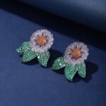 Wholesale zircon flower earrings with white pavé petals on real gold plated copper from JuneJewelry.com – luxury floral studs for bulk orders.