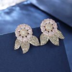 Wholesale zircon flower earrings with white pavé petals on real gold plated copper from JuneJewelry.com – luxury floral studs for bulk orders.